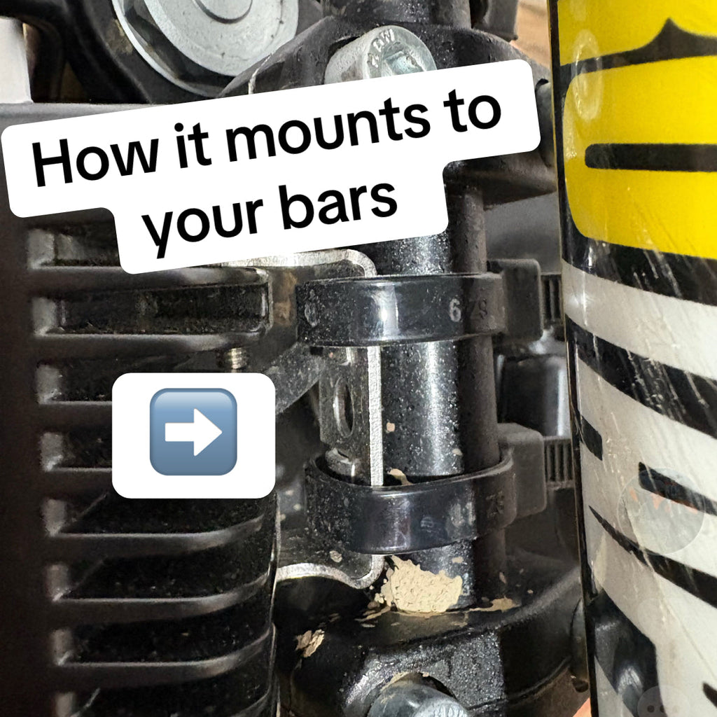 Close-up of a motorcycle handlebar control with text and arrow indicating mounting instructions.