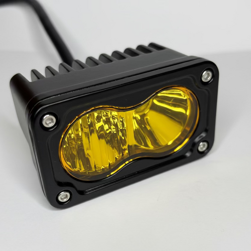 Yellow LED light with black casing on a white background