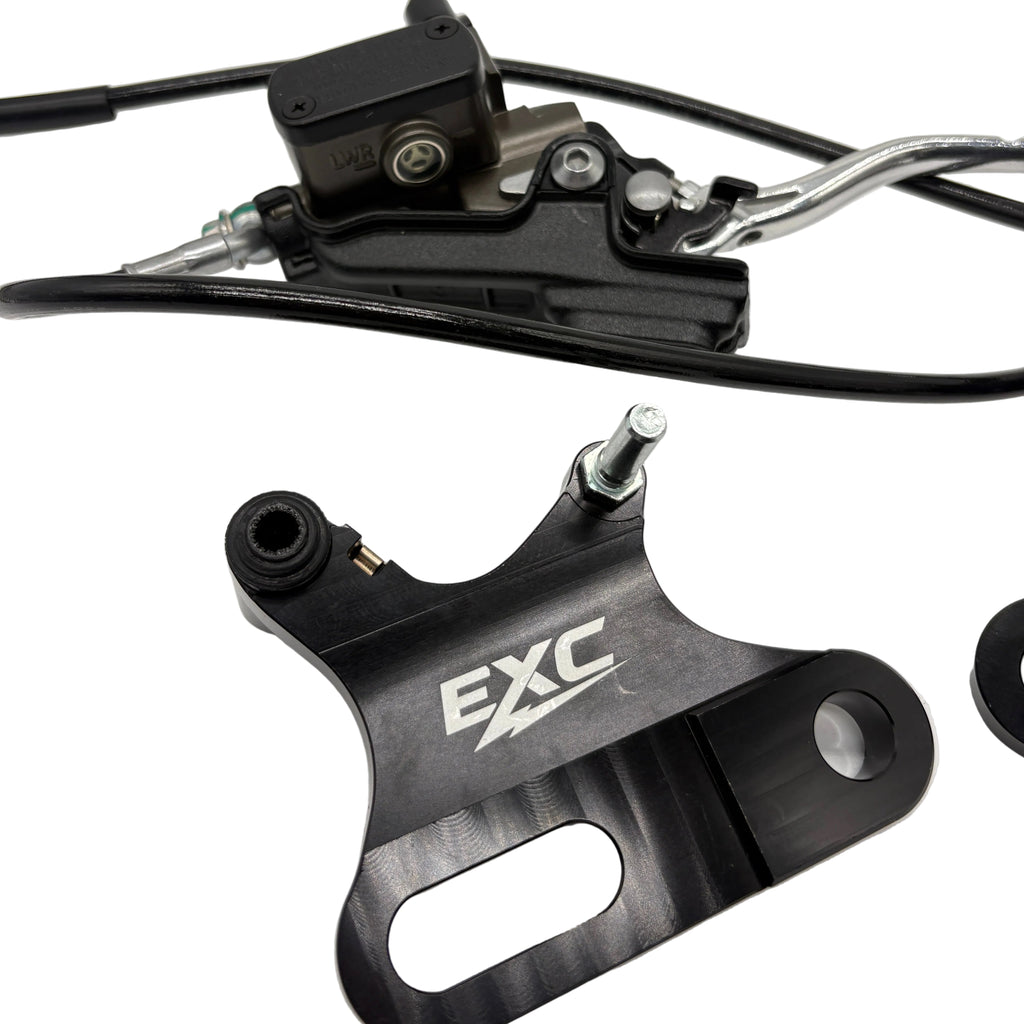 Close-up of a bicycle brake lever with 'EXC' branding on a white background