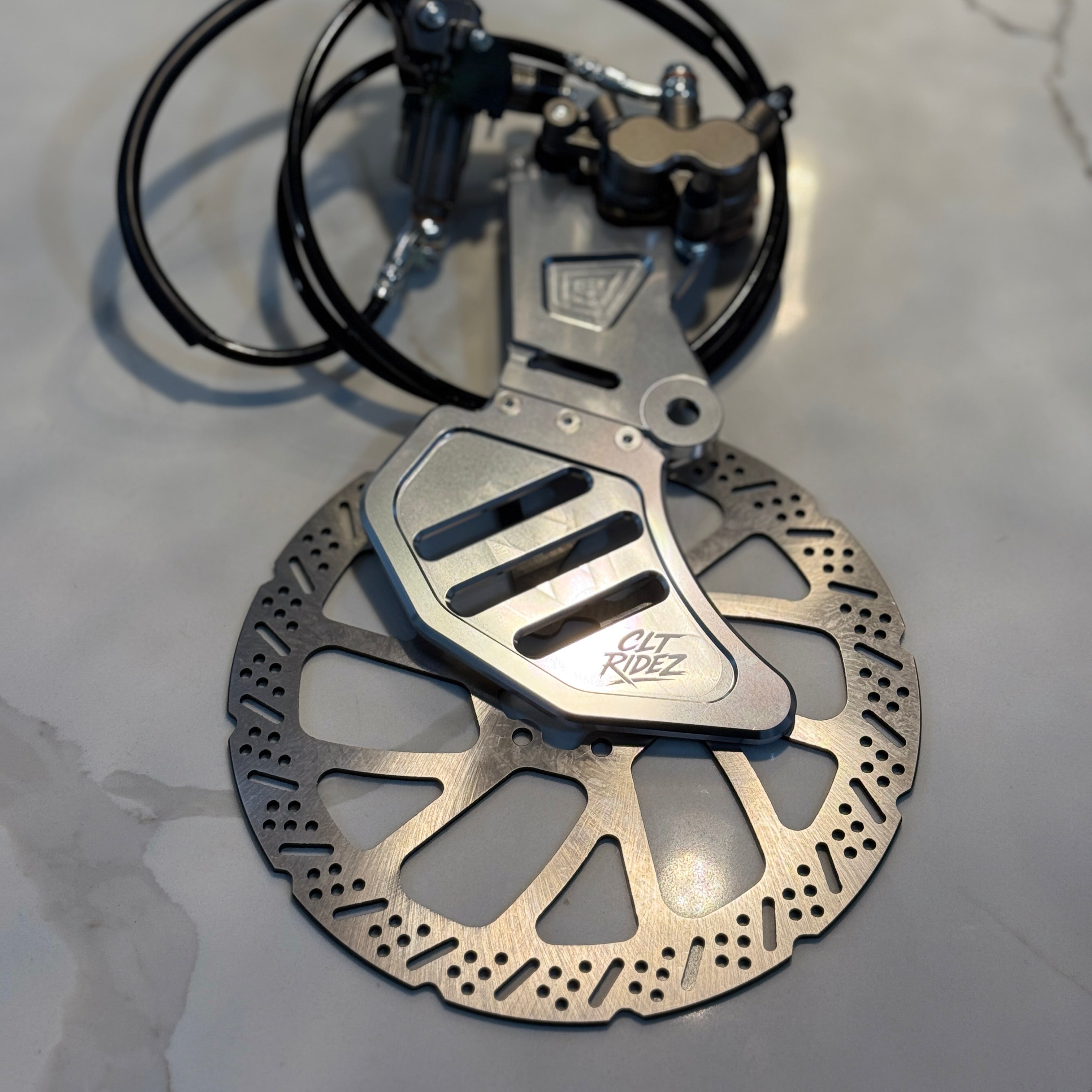Bicycle brake mechanism with rotor on a gray surface