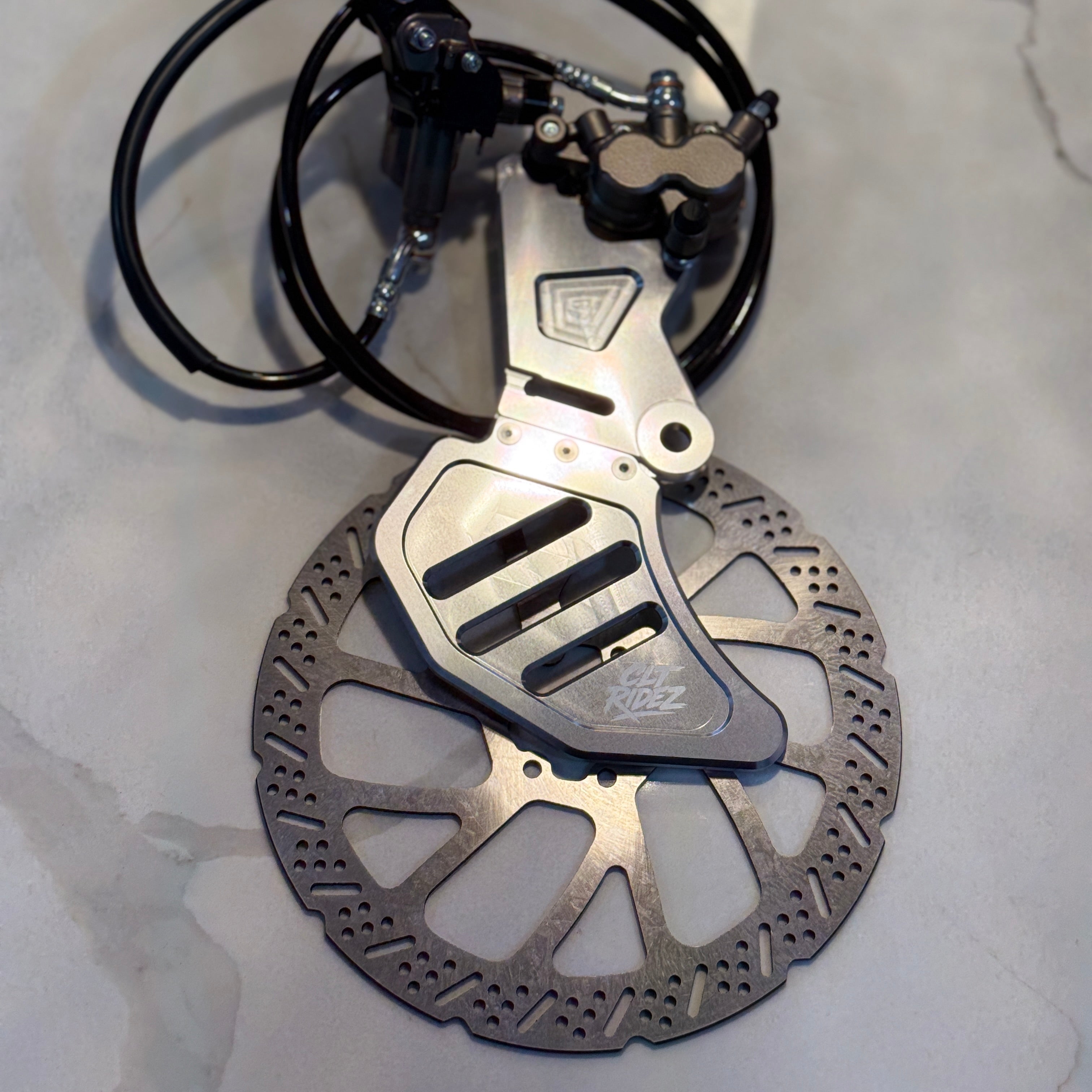 Bicycle disc brake assembly on a gray surface