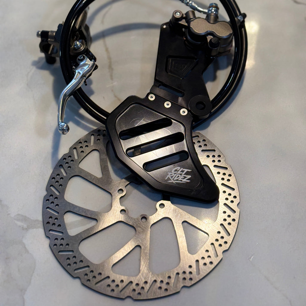Motorcycle brake disc and caliper on a light gray background