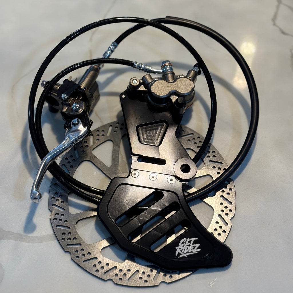 Bicycle brake system with disc and caliper on a light gray background