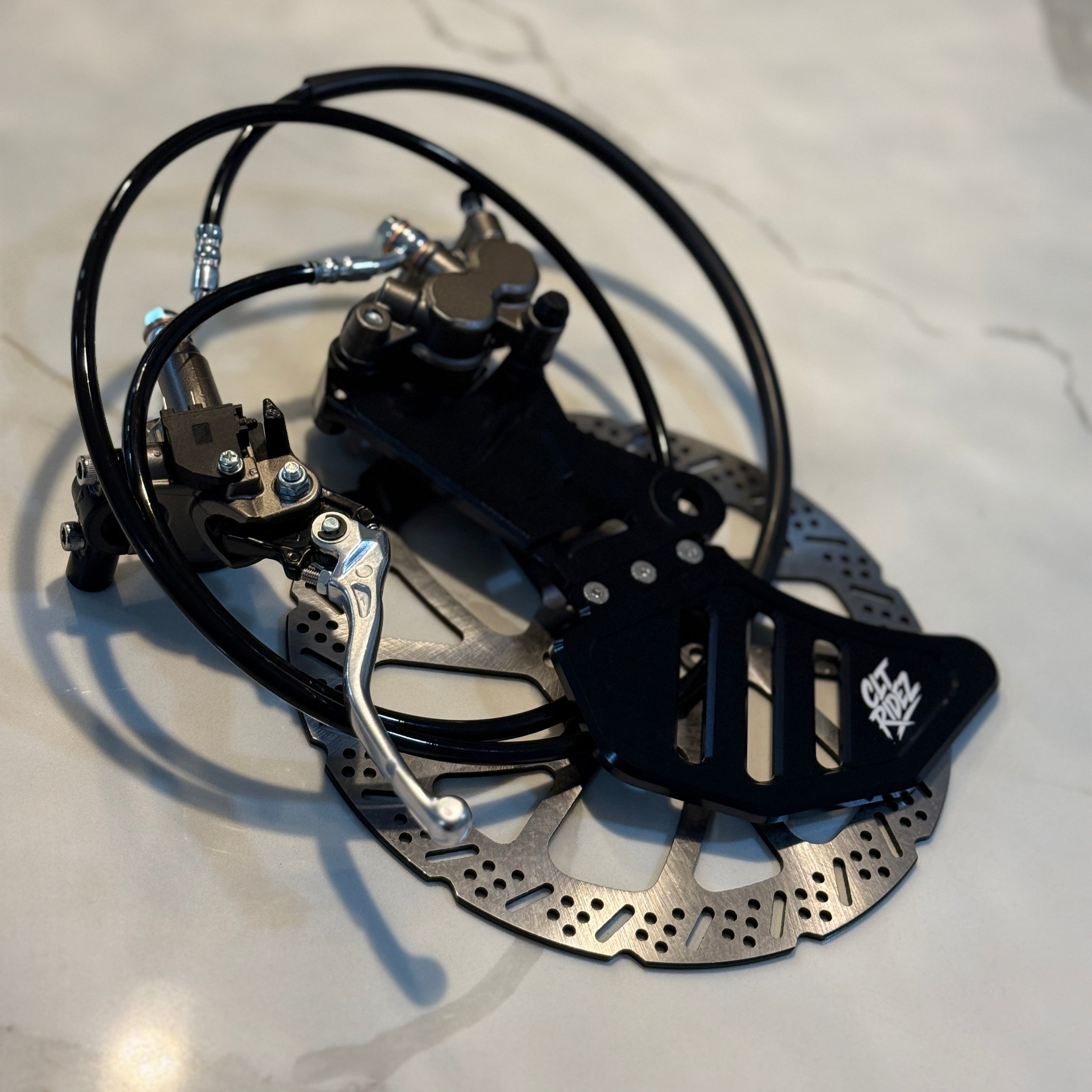 Bicycle disc brake assembly on a light-colored surface