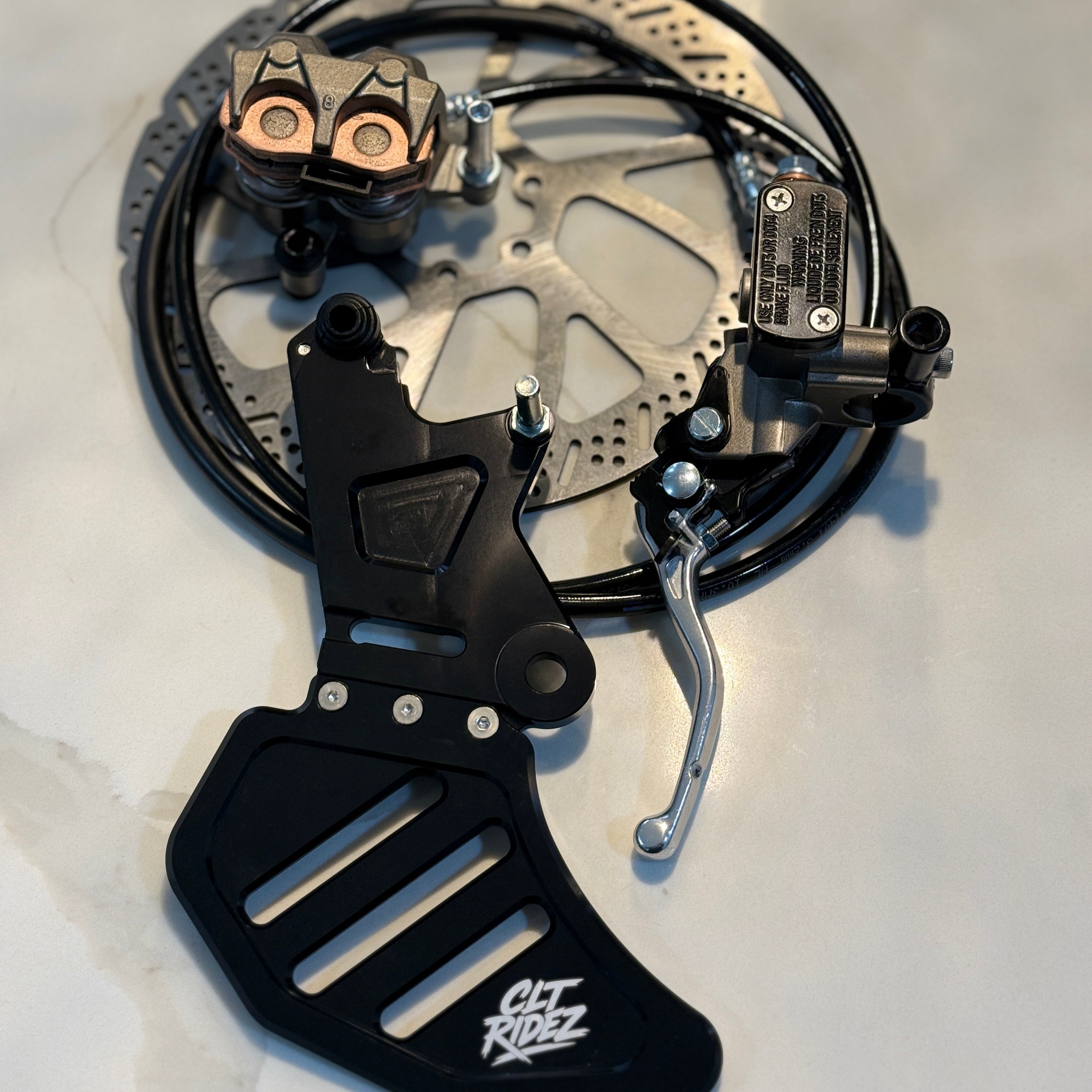 Motorcycle brake lever and caliper assembly on a white background
