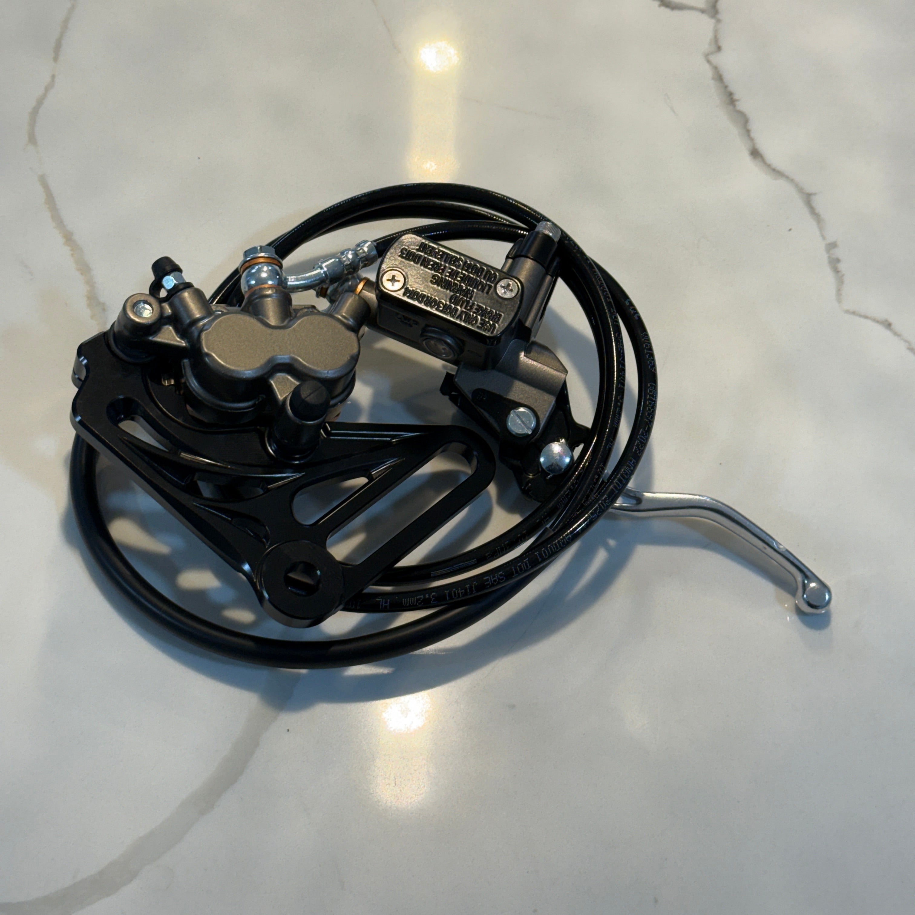 Mechanical brake assembly on a light gray surface