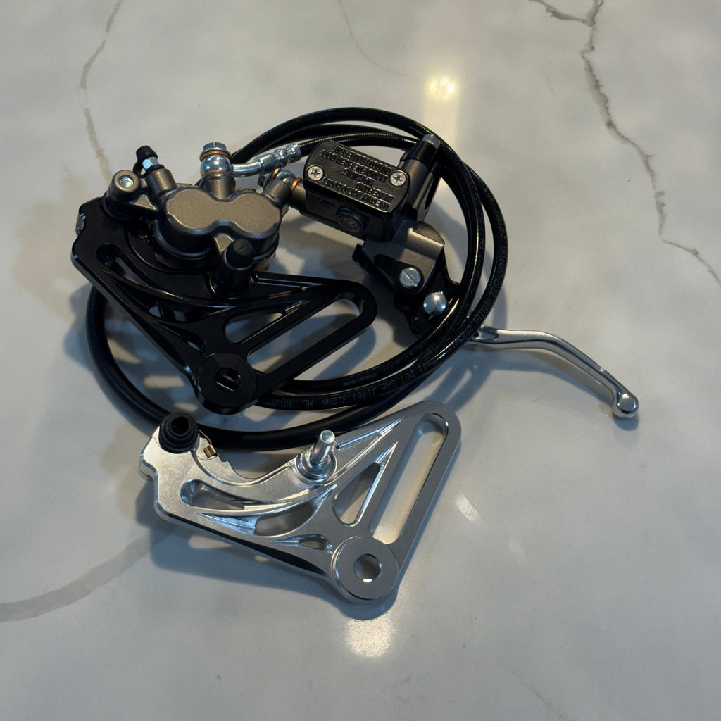 Mechanical component with black cable and metal parts on a marble surface