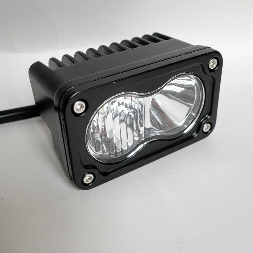 Black LED work light on a gray background