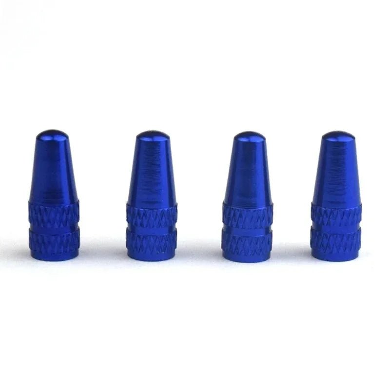 Four blue metal valve stem caps on a white background