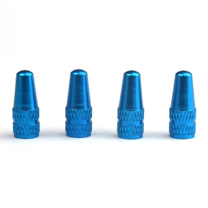 Four blue metal valve stem caps on a white background